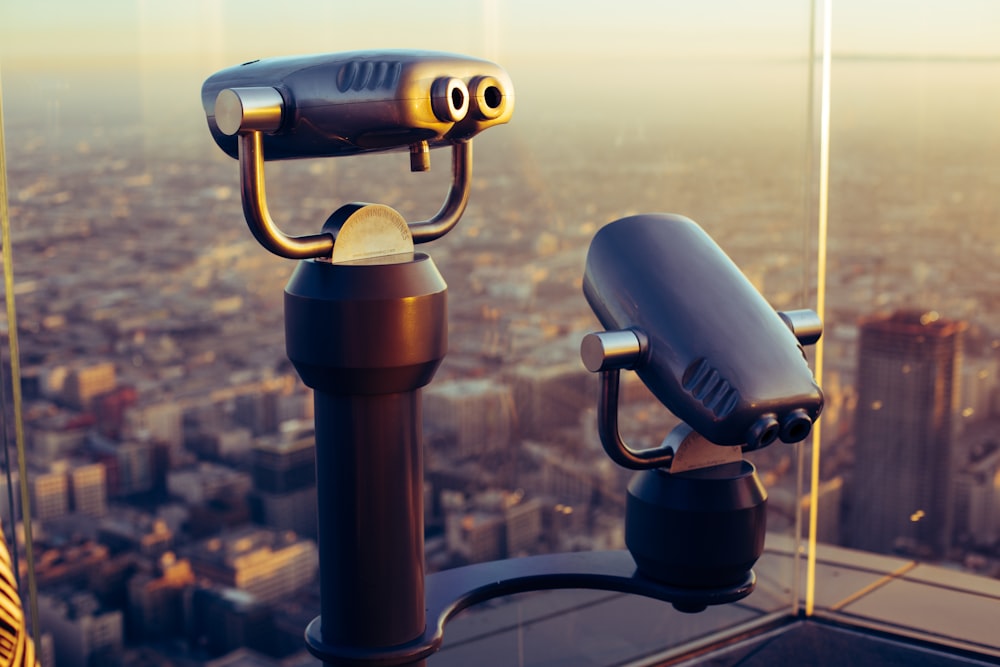 black binoculars on brown metal stand