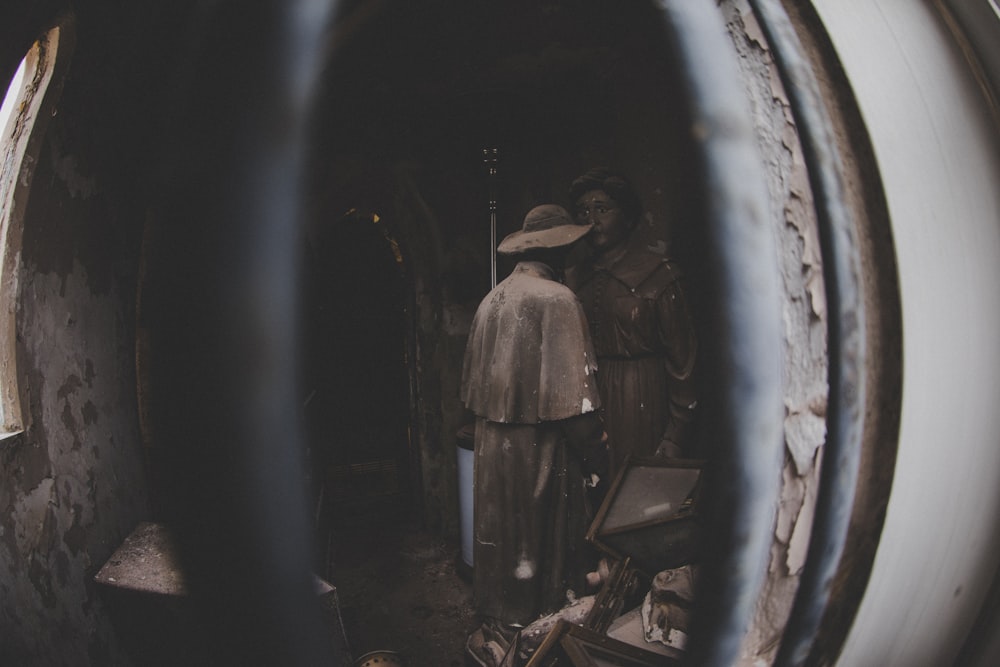 man in brown jacket standing in tunnel