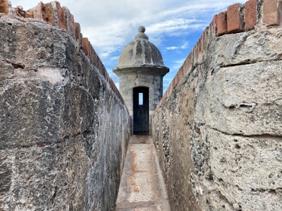 brown brick wall under blue sky during daytime