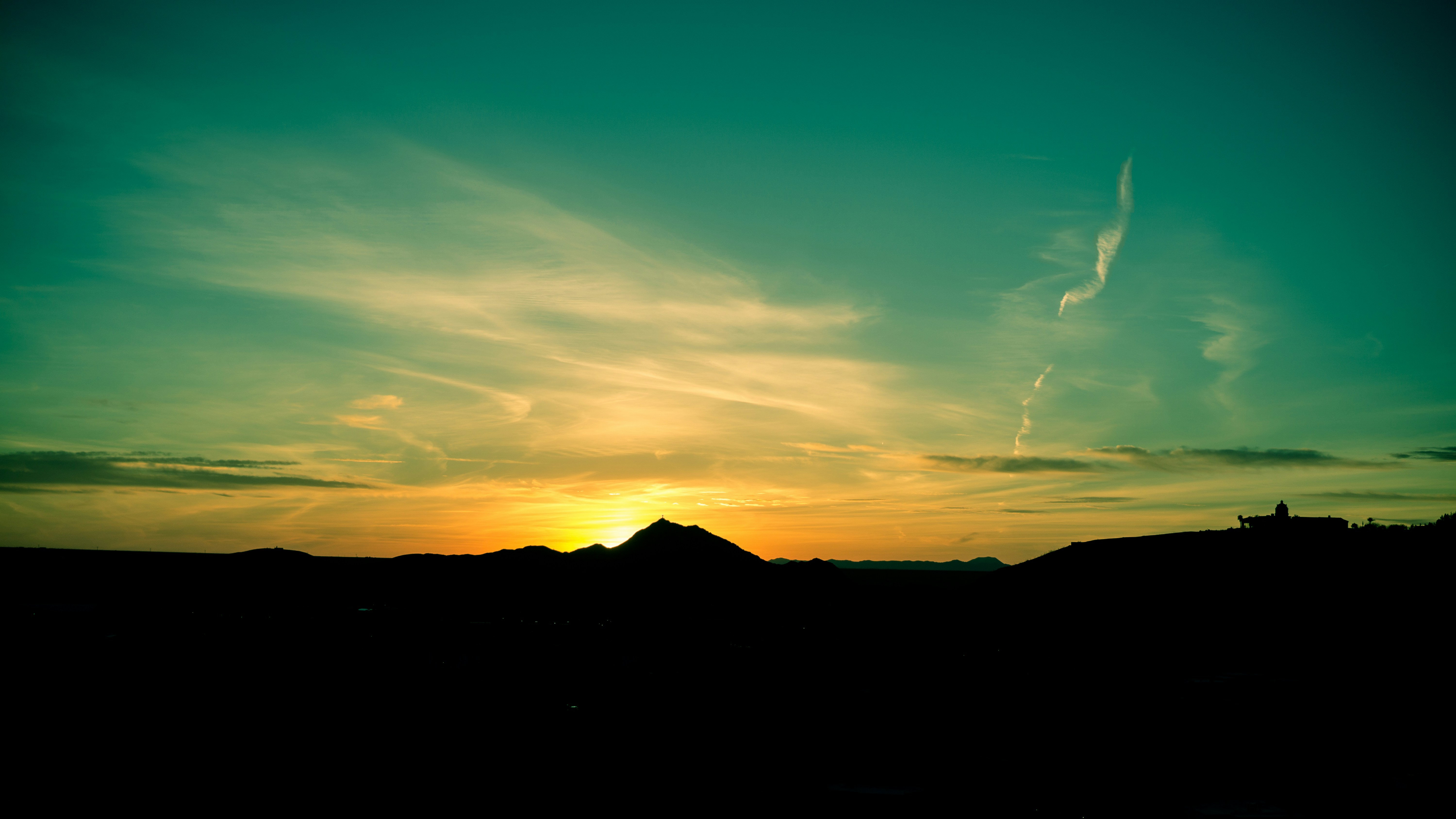 silhouette of mountain under blue sky during daytime