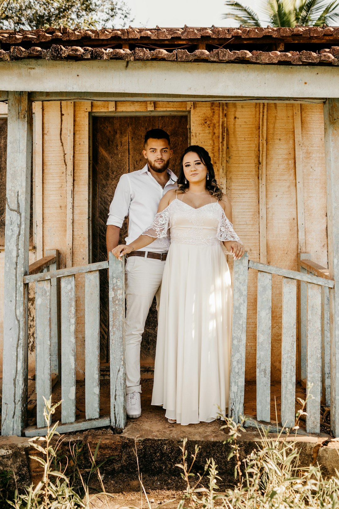 woman in white dress standing beside brown wooden wall