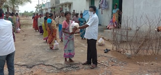 Locals gathered around a delivery point receiving medicines and goods.