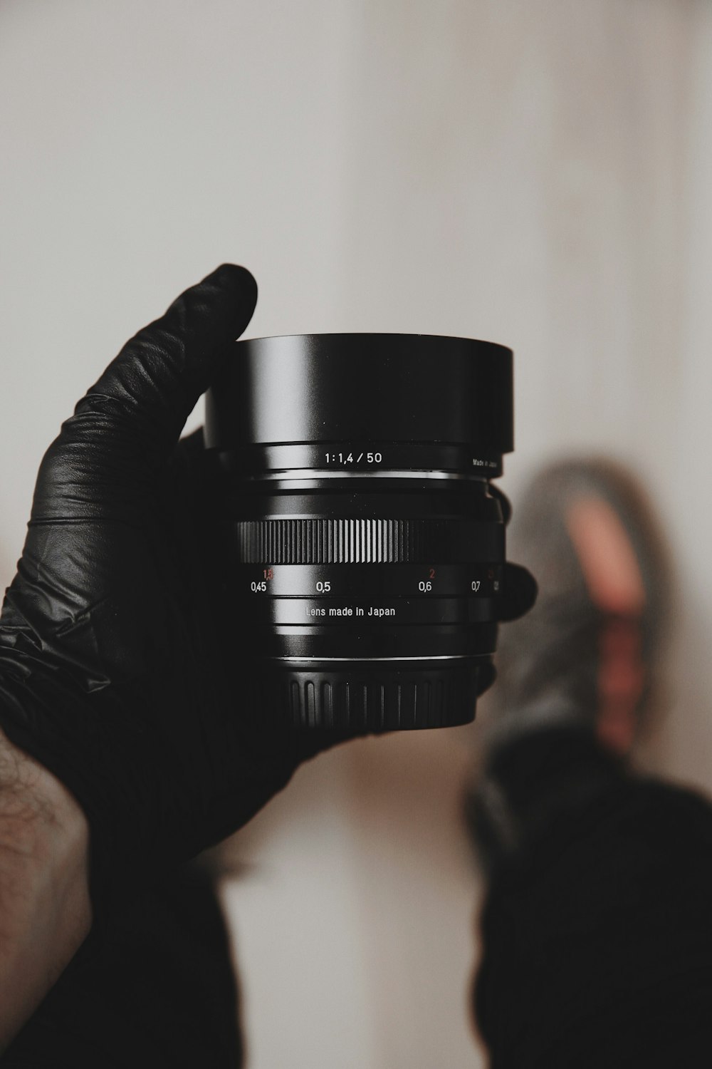 person holding black camera lens