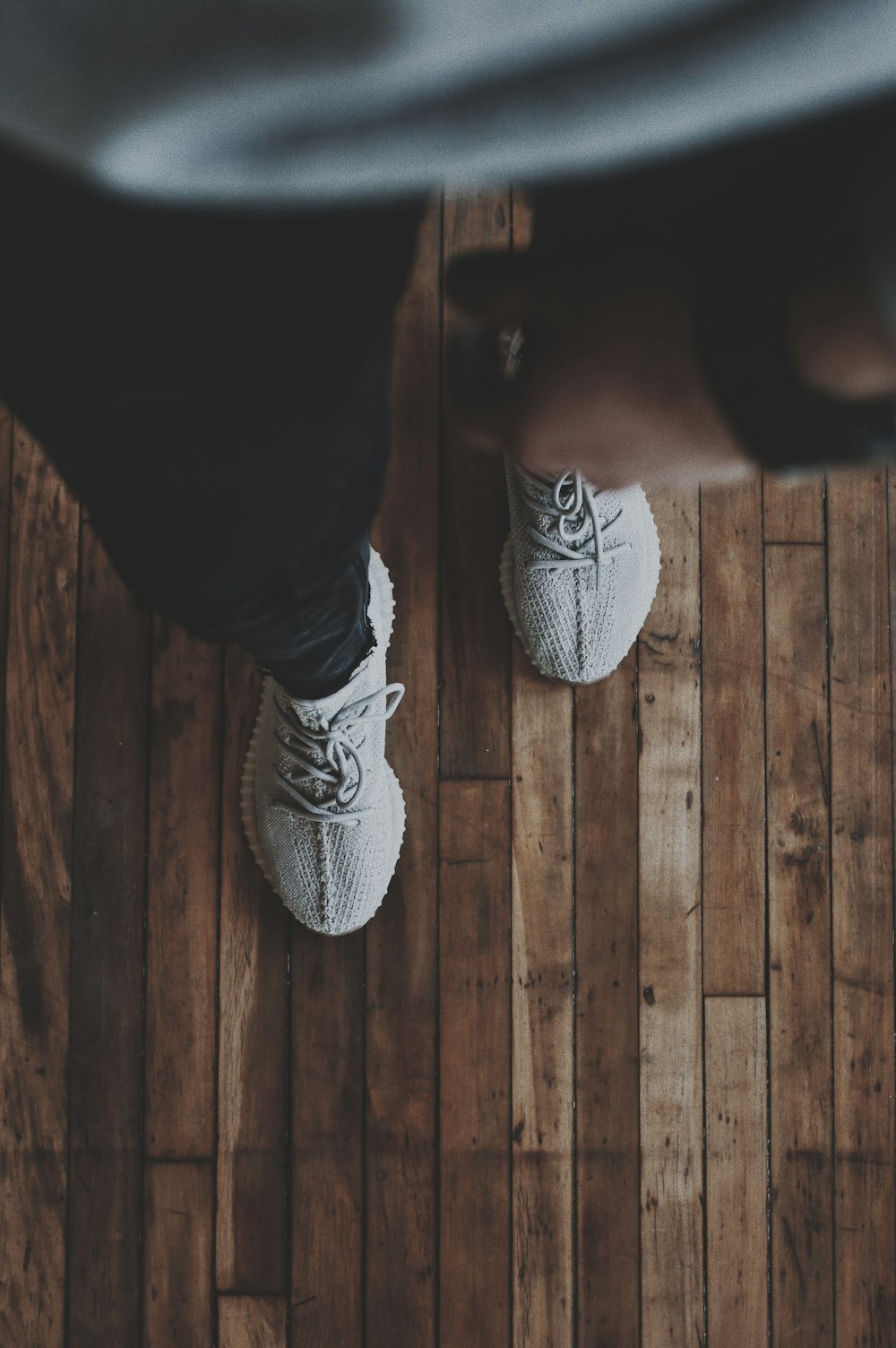 person in black pants and black and white nike sneakers