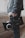 A person holds a professional video camera, wearing a denim jacket. The camera appears to be a high-end model, possibly used for filmmaking or professional video production.
