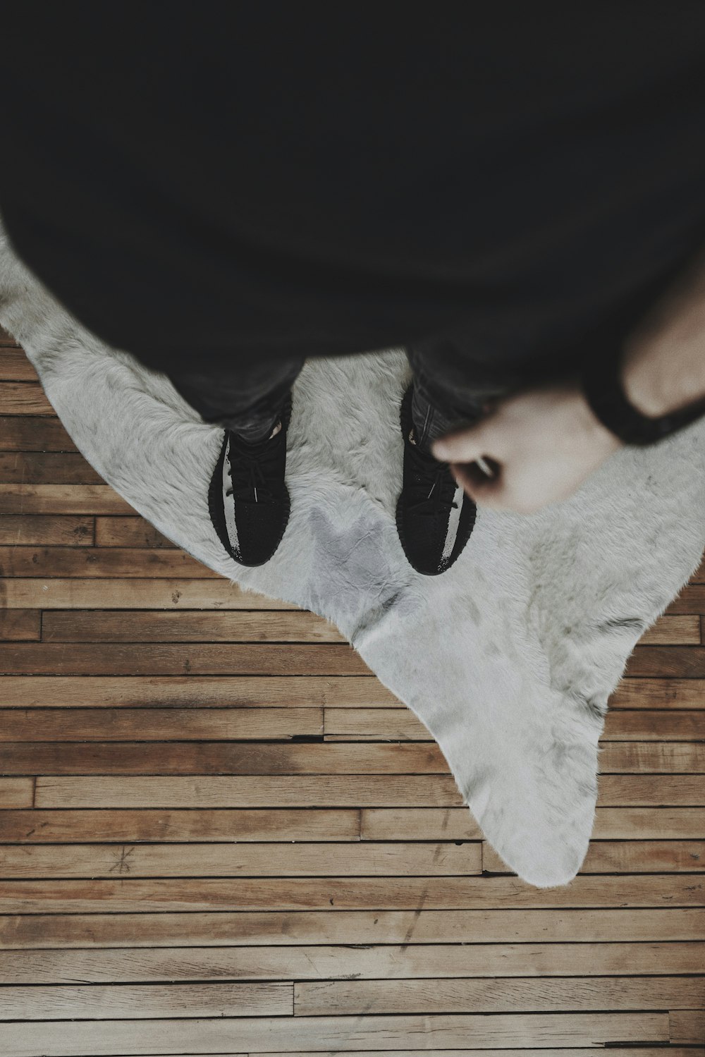 person in black shirt and white socks