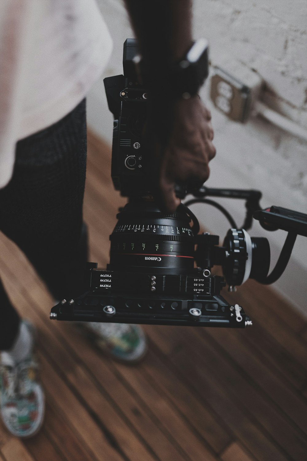 black video camera on brown wooden table