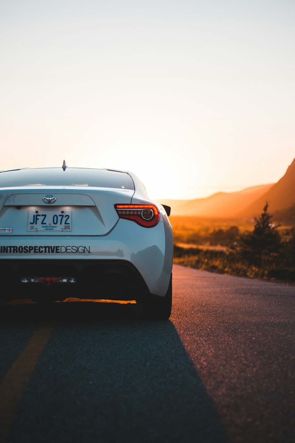 white porsche 911 on road during sunset