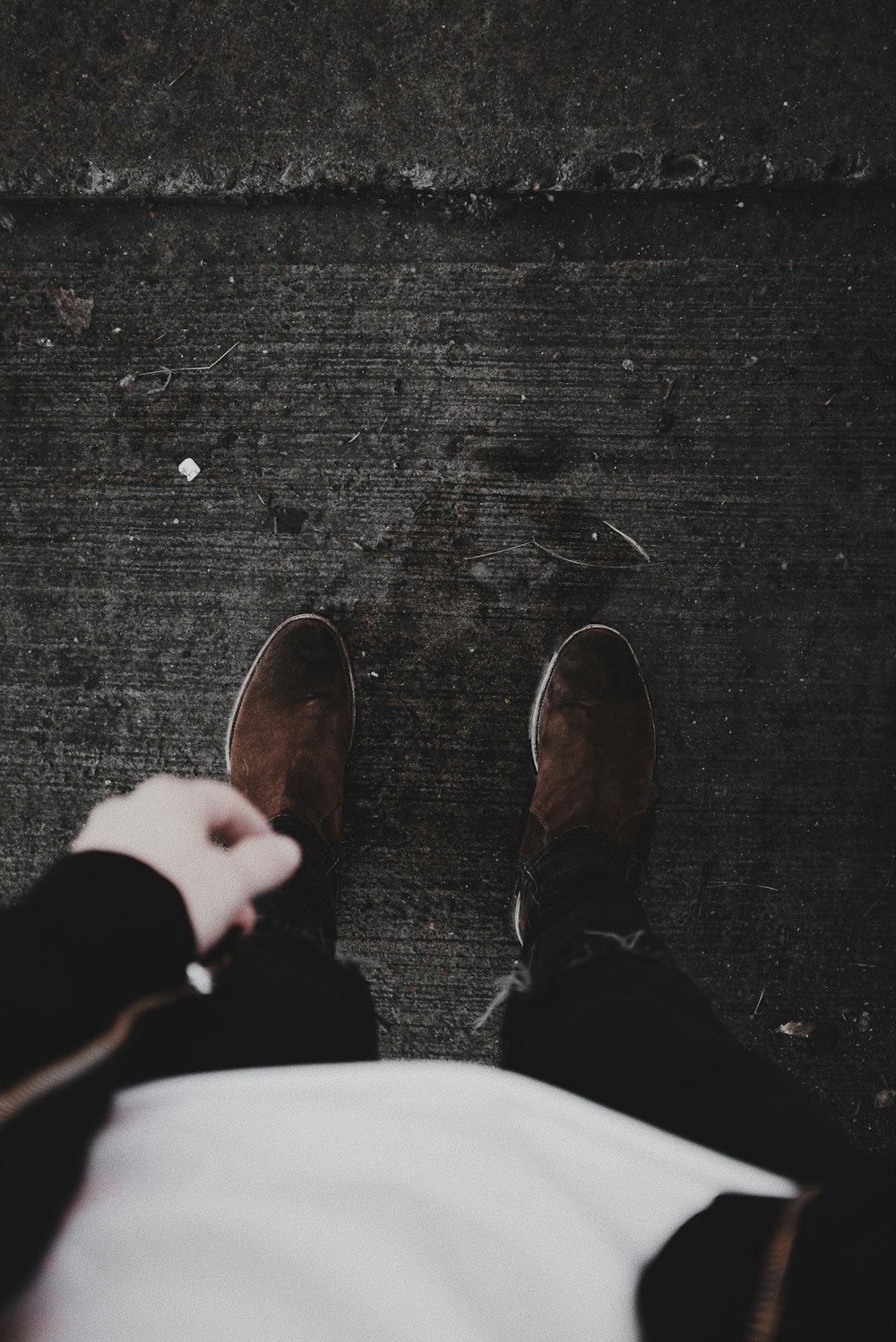 person in black pants and brown shoes