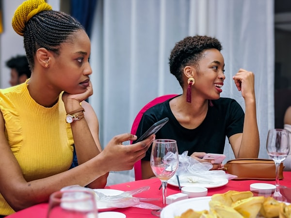 Group of women friends in an animated conversation sharing gossip and laughing together