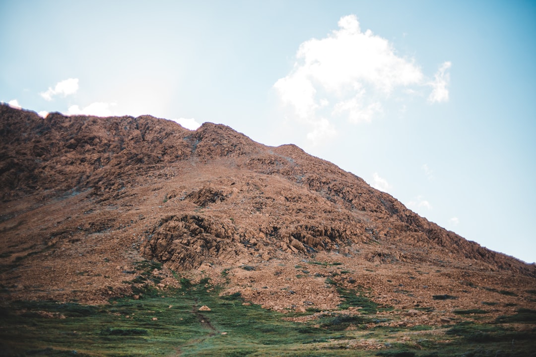 brown mountain under blue sky during daytime