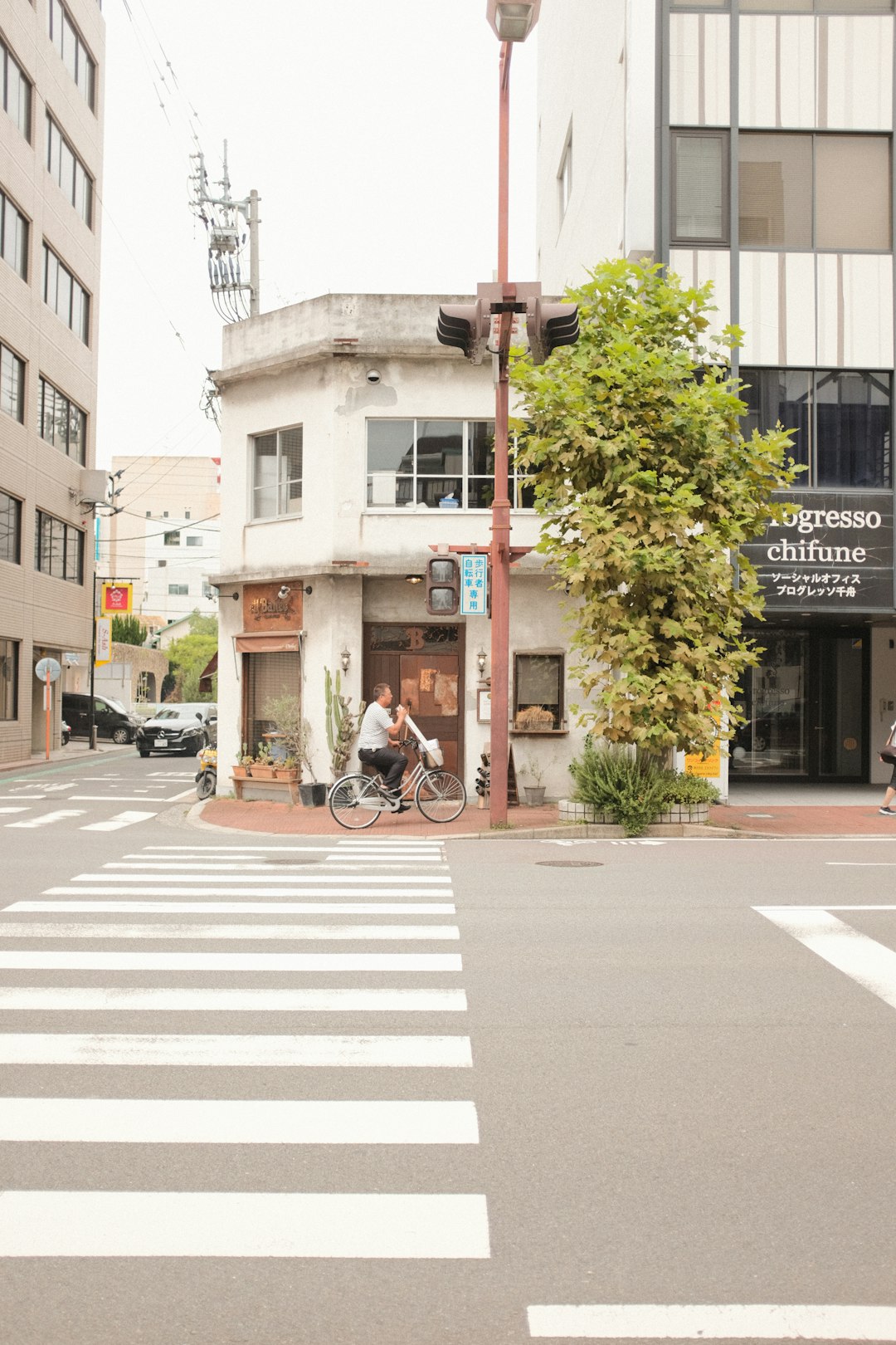 man in black jacket riding bicycle on pedestrian lane during daytime