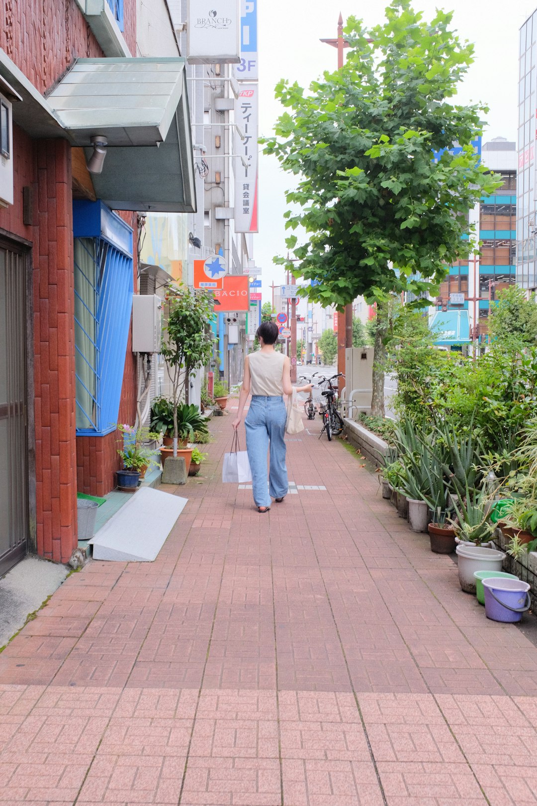 man and woman walking on sidewalk during daytime