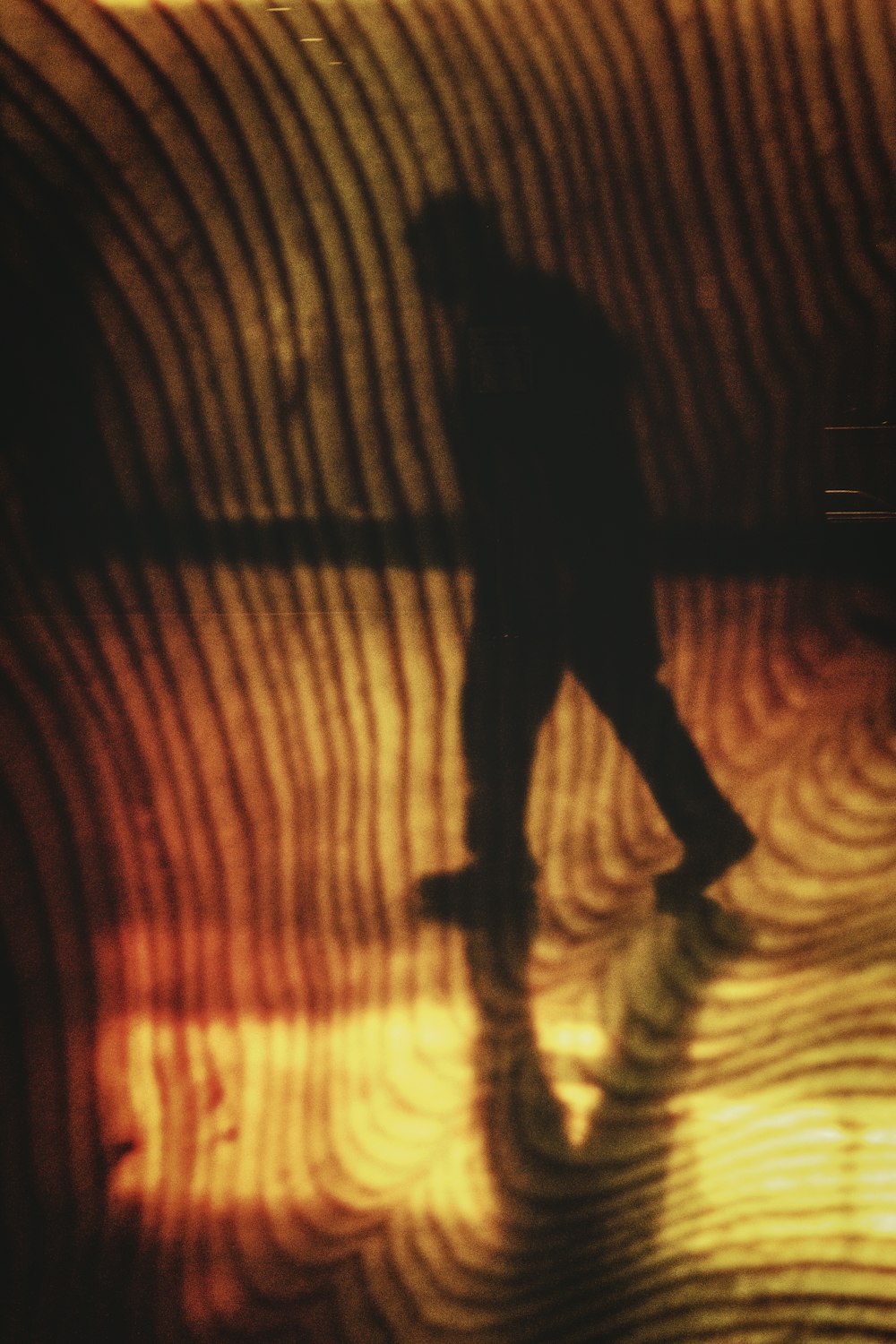 silhouette of person walking on tunnel