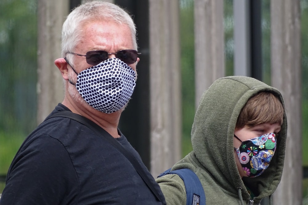 man in black shirt wearing sunglasses and green knit cap