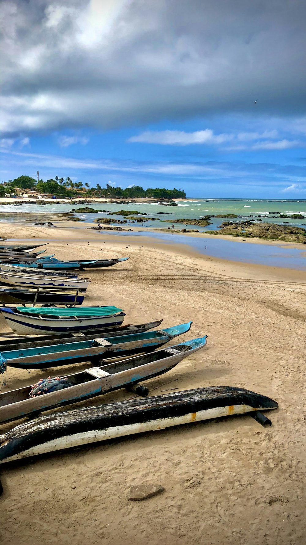 blue and white boats on beach during daytime