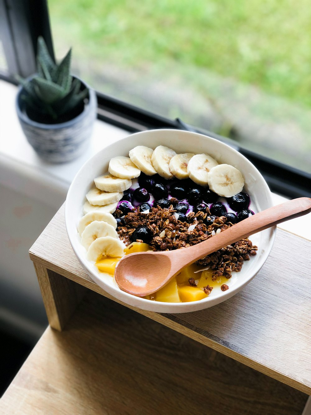 sliced banana and orange fruit on white ceramic plate