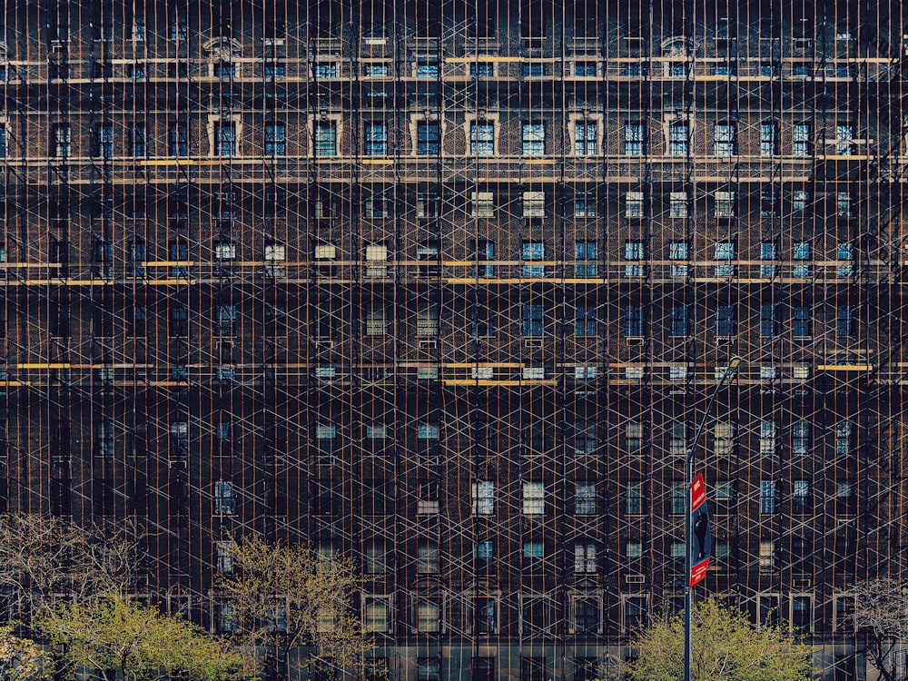 person in red jacket standing in front of building during daytime