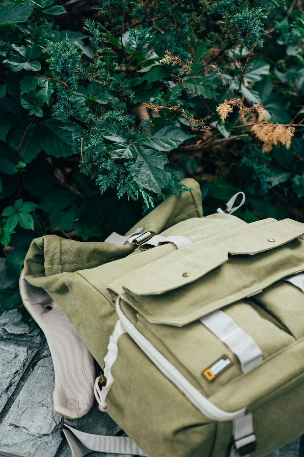 white leather handbag on gray textile