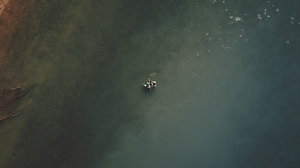 2 people riding on boat on water during daytime