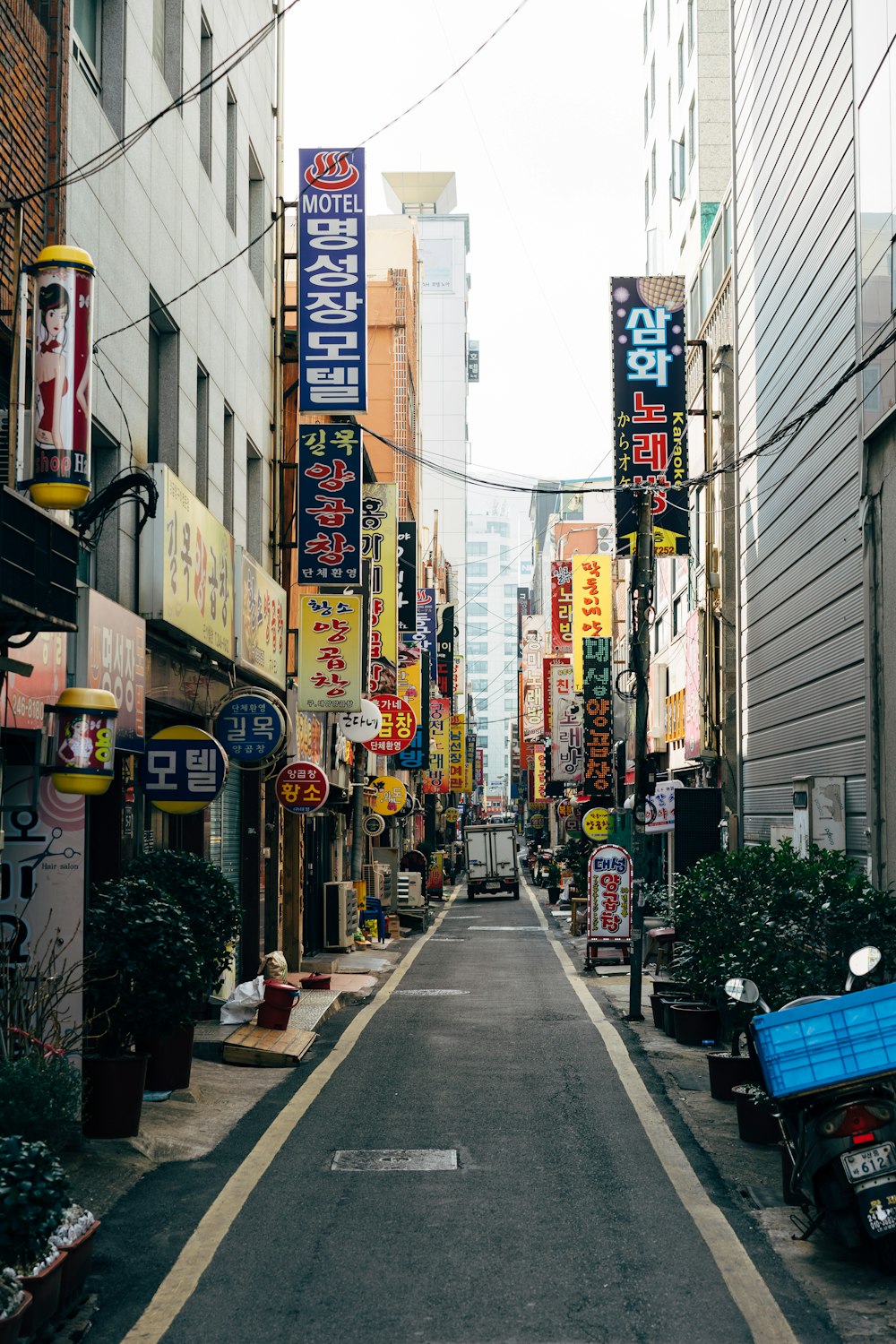 people walking on sidewalk near buildings during daytime