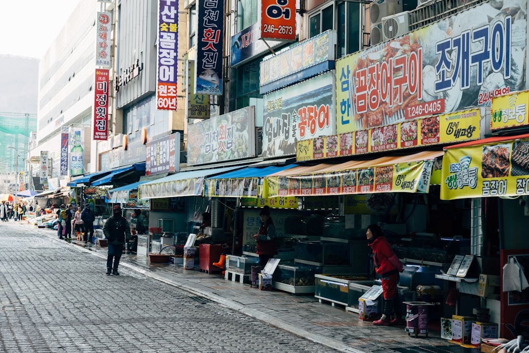 people walking on sidewalk near store during daytime