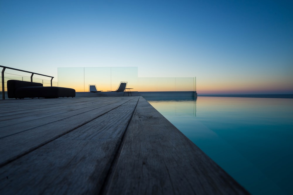 brown wooden dock on blue sea during daytime