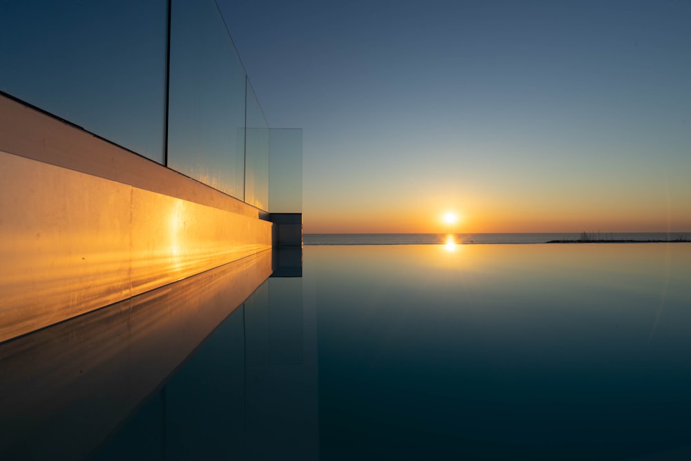 brown wooden dock over calm water during daytime