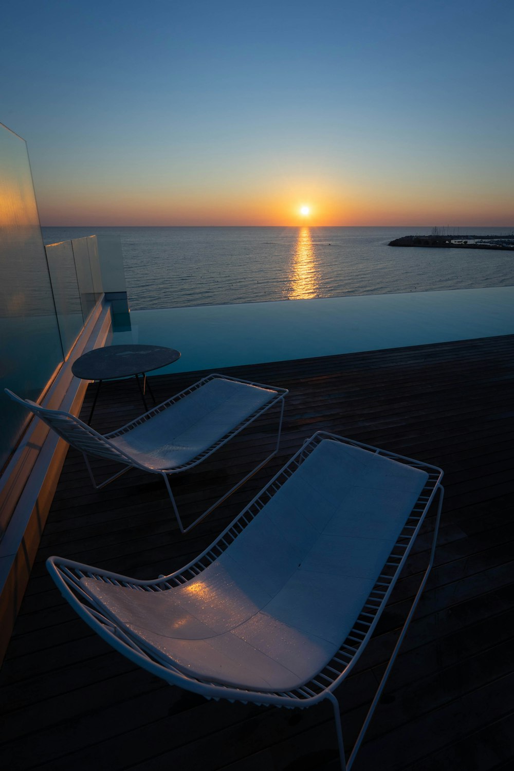 white and blue boat on sea during sunset