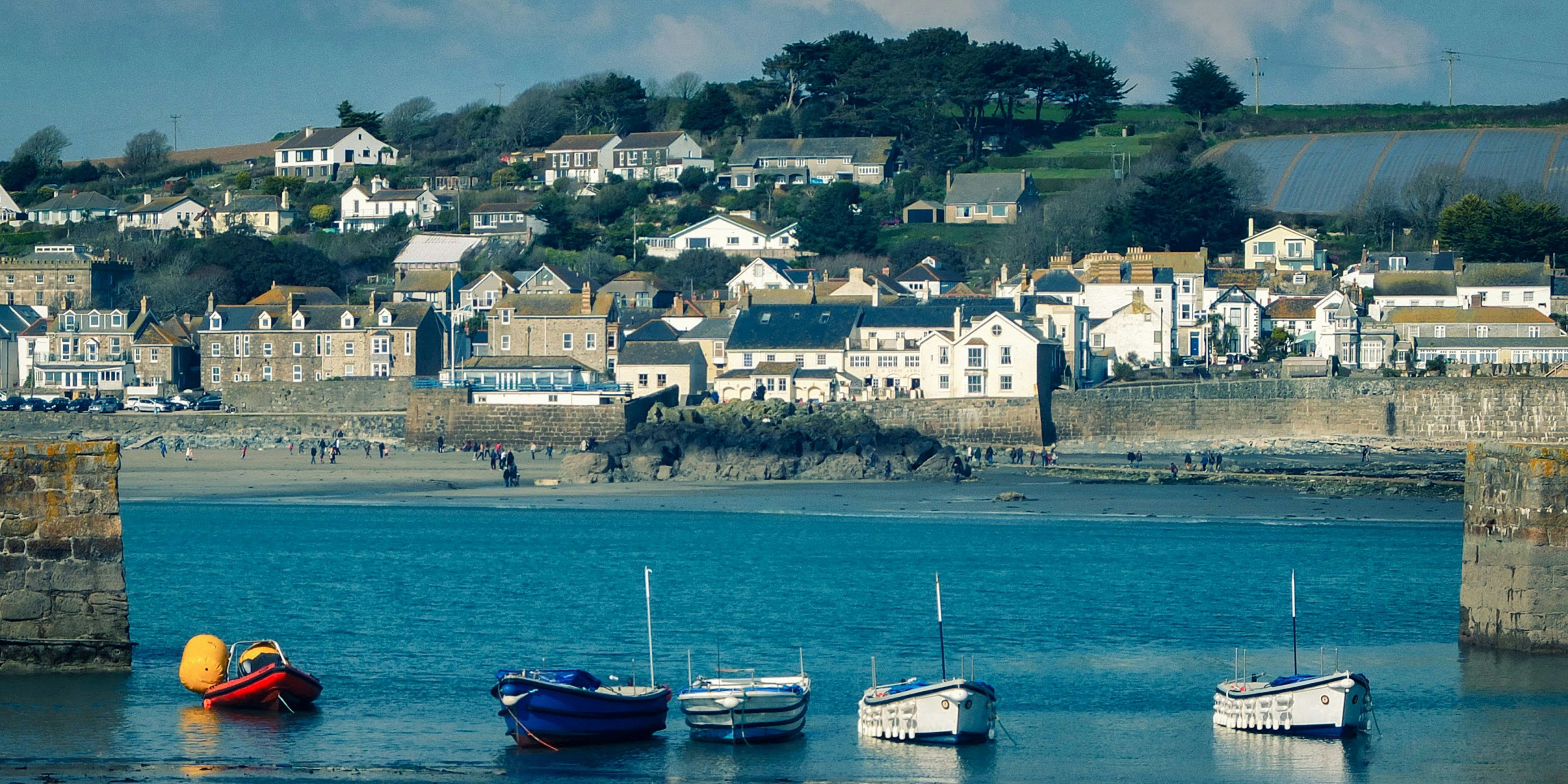 blue and white boat on sea during daytime