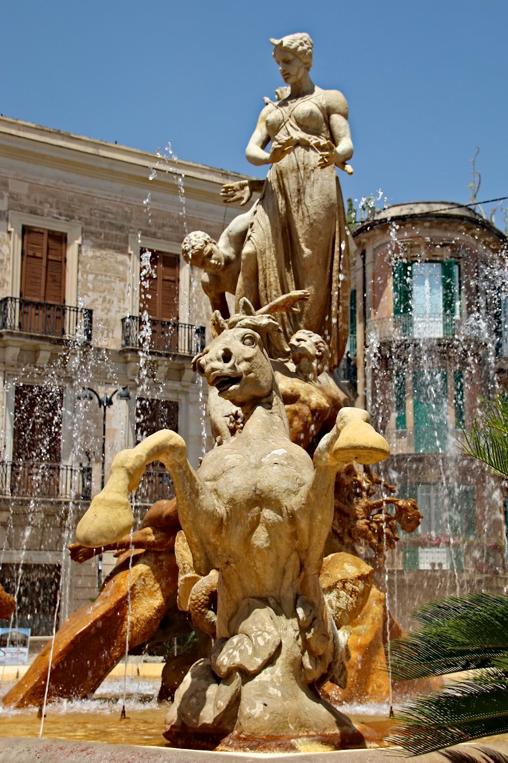 gold statue fountain during daytime