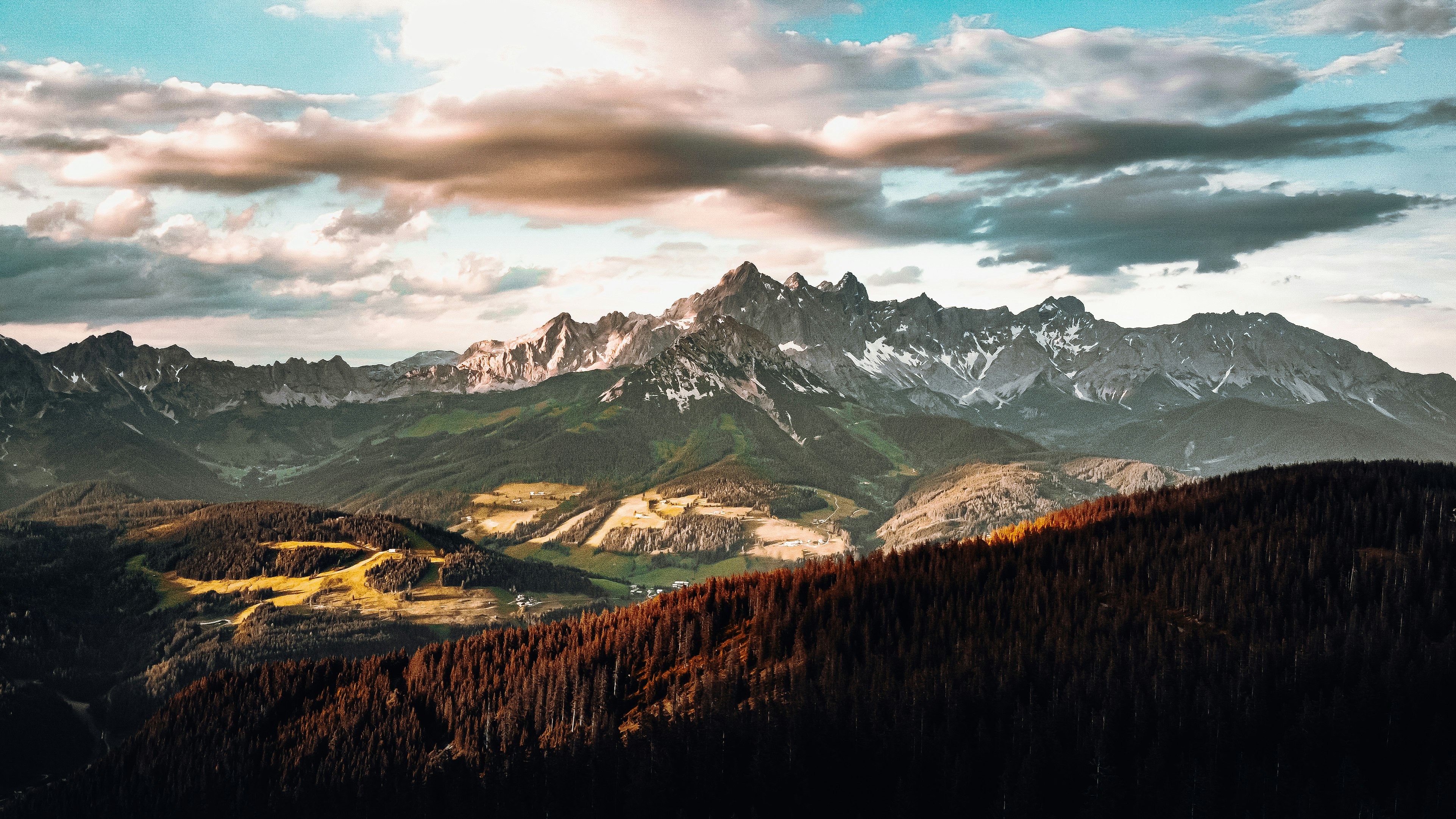 green trees near snow covered mountain during daytime