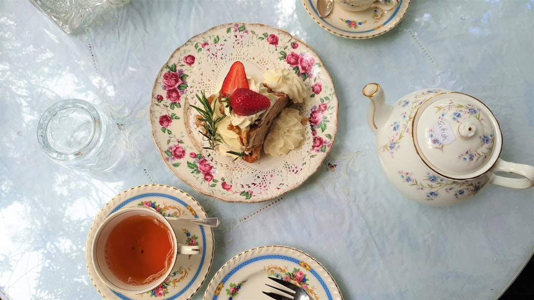 strawberry ice cream on white and green floral ceramic plate,