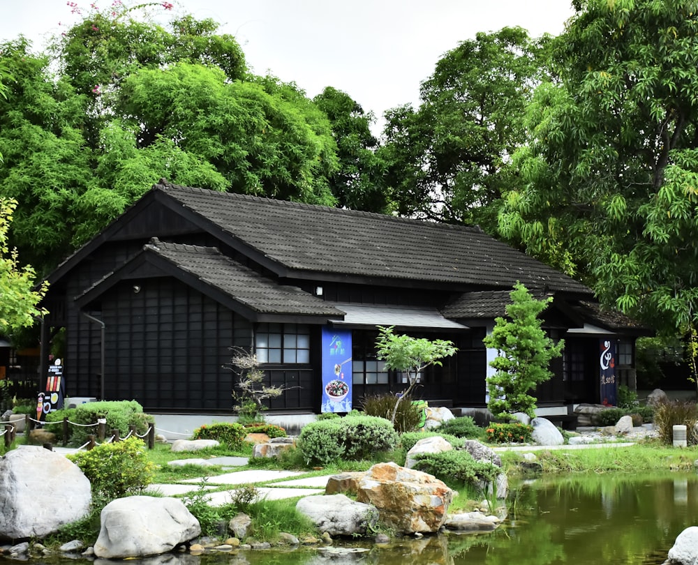 black and white wooden house near green trees during daytime
