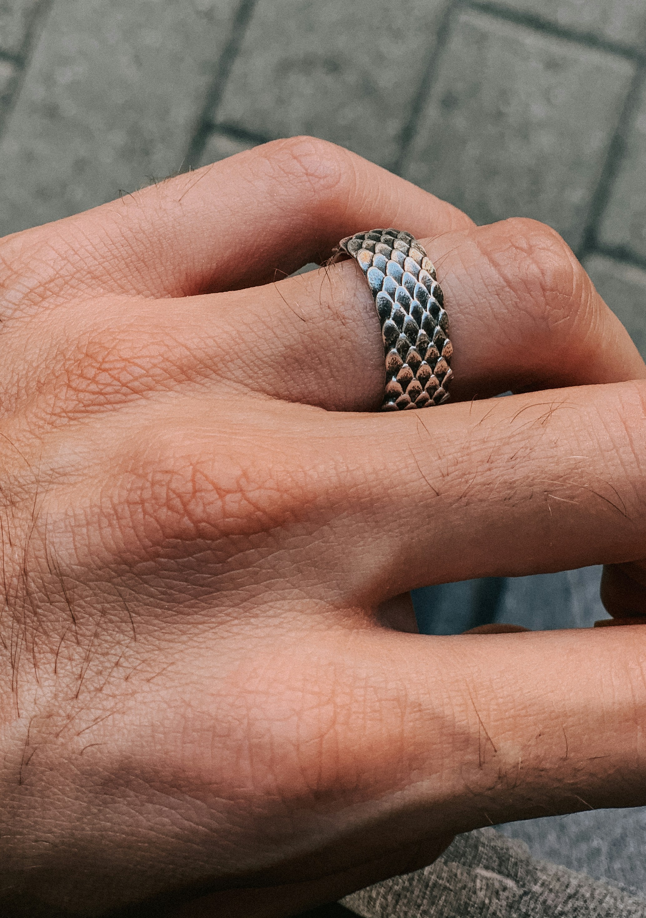 silver and diamond ring on persons hand