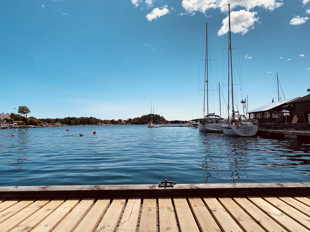 white boat on sea dock during daytime