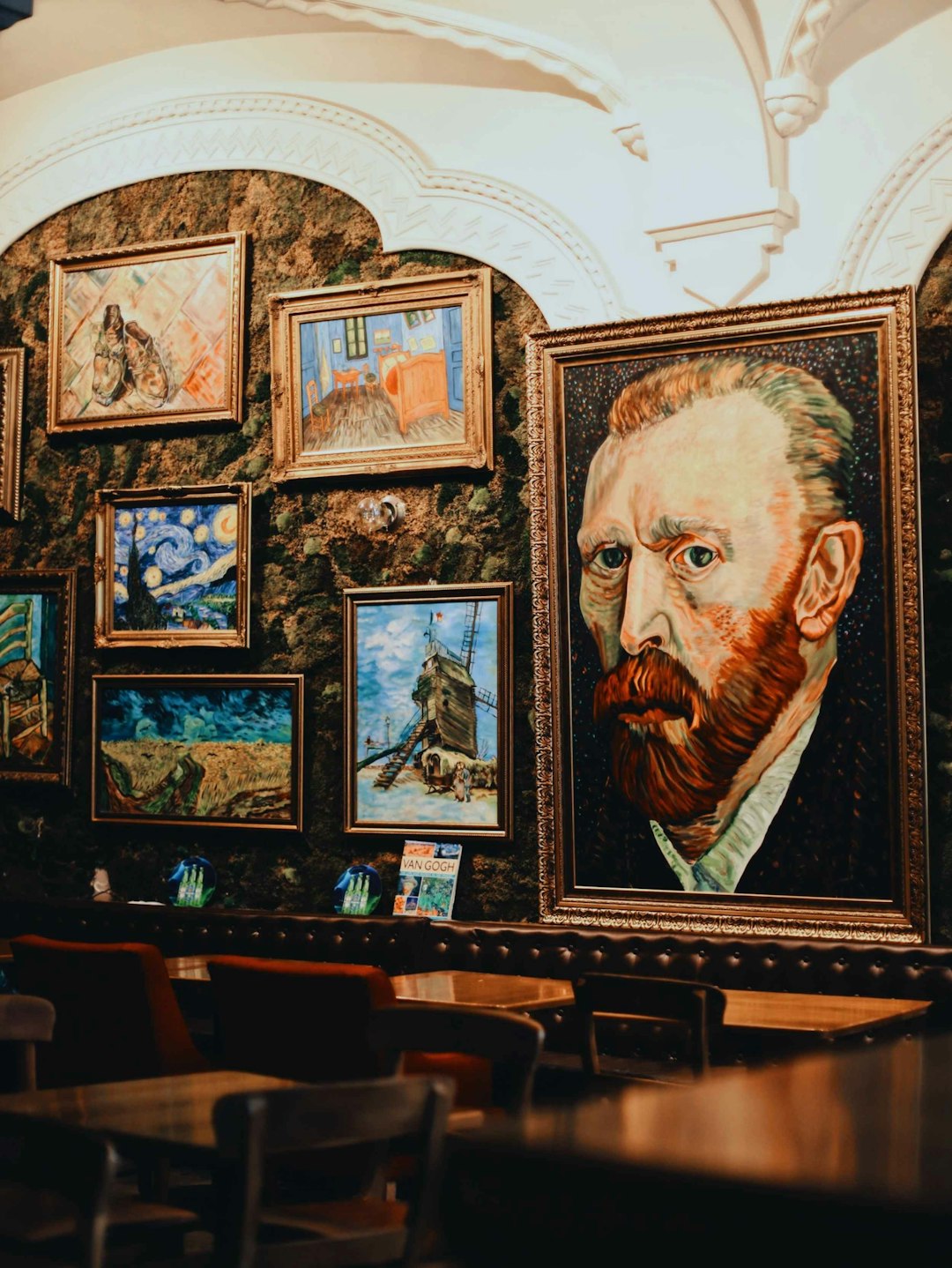 man in brown suit painting