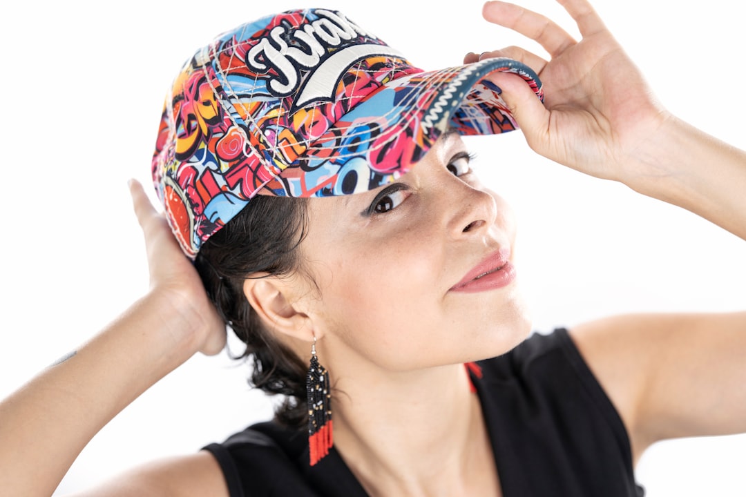 woman in black tank top wearing blue and white floral headdress