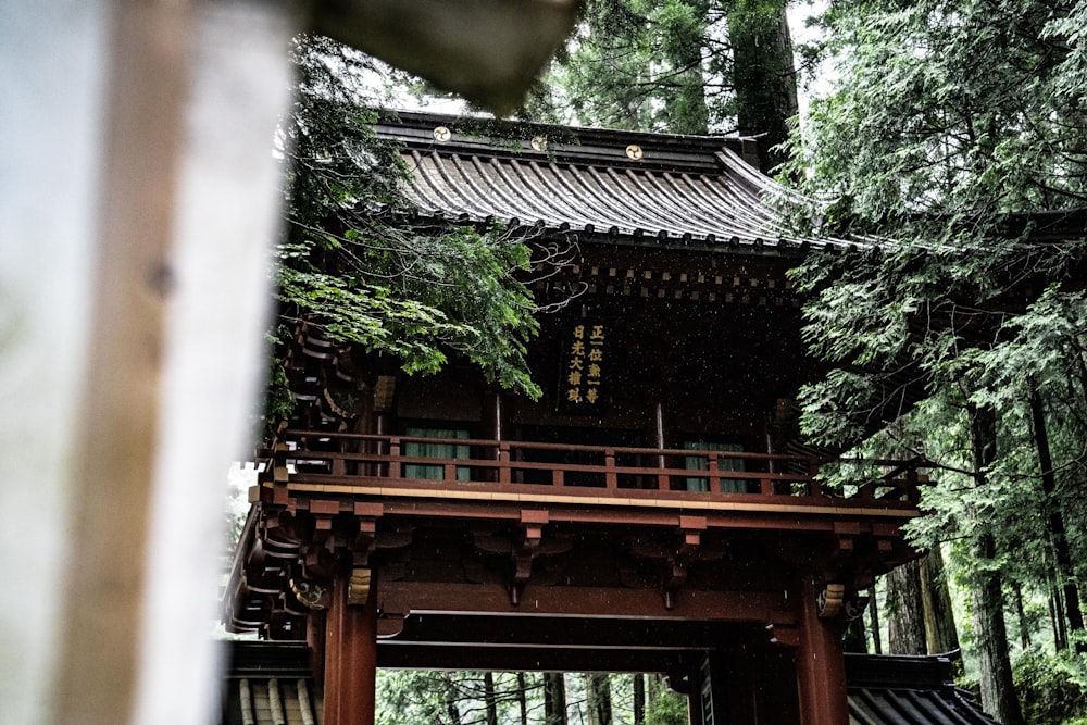 brown wooden temple surrounded by green trees during daytime