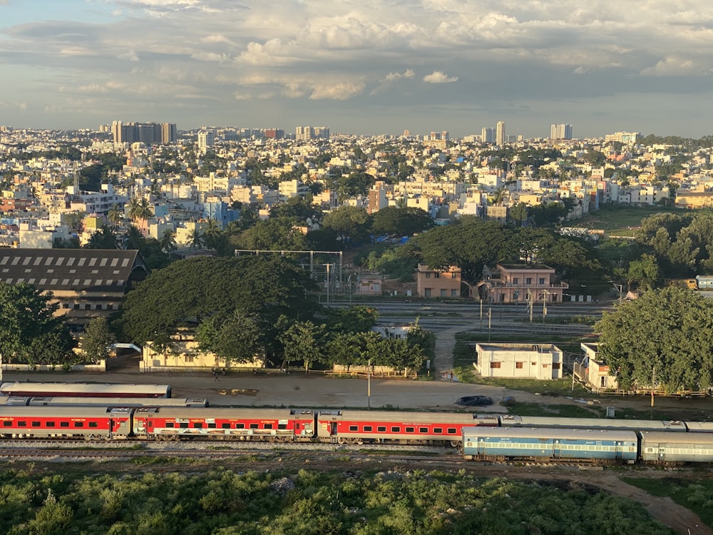 white and red train on rail road during daytime