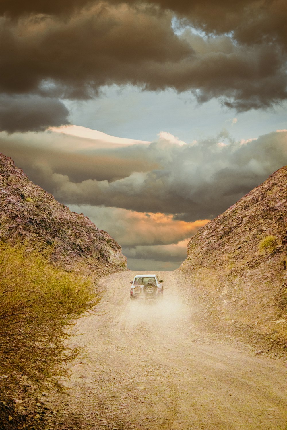 white suv on brown dirt road during daytime