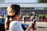woman in white shirt holding black dslr camera