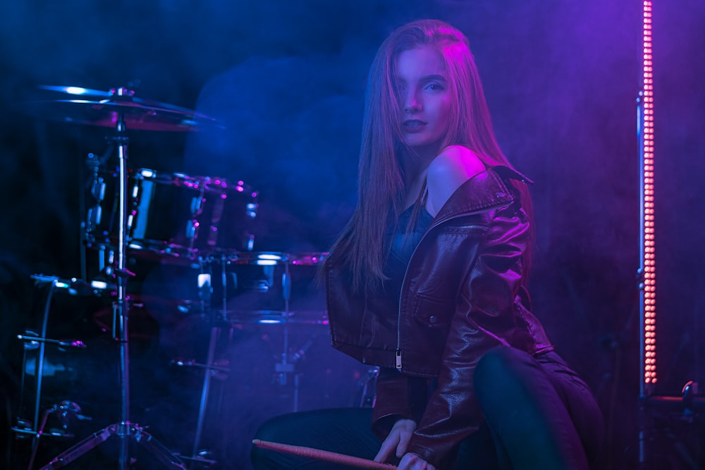 woman in black leather jacket sitting on black chair