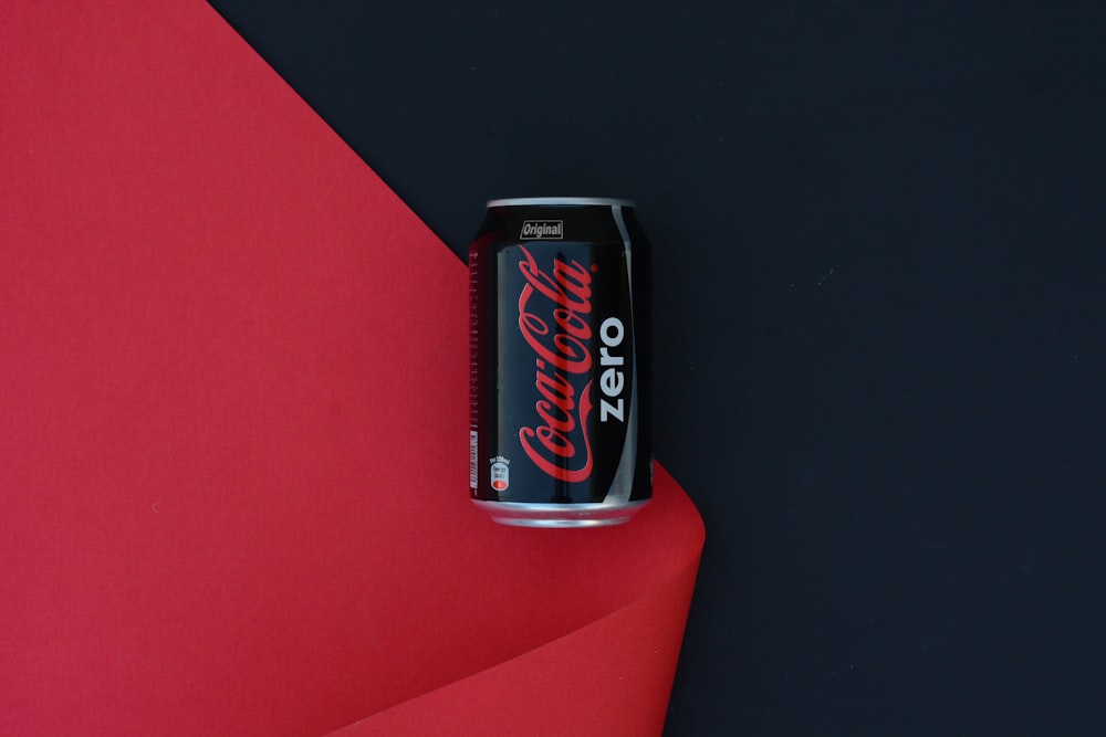 coca cola zero can on red table