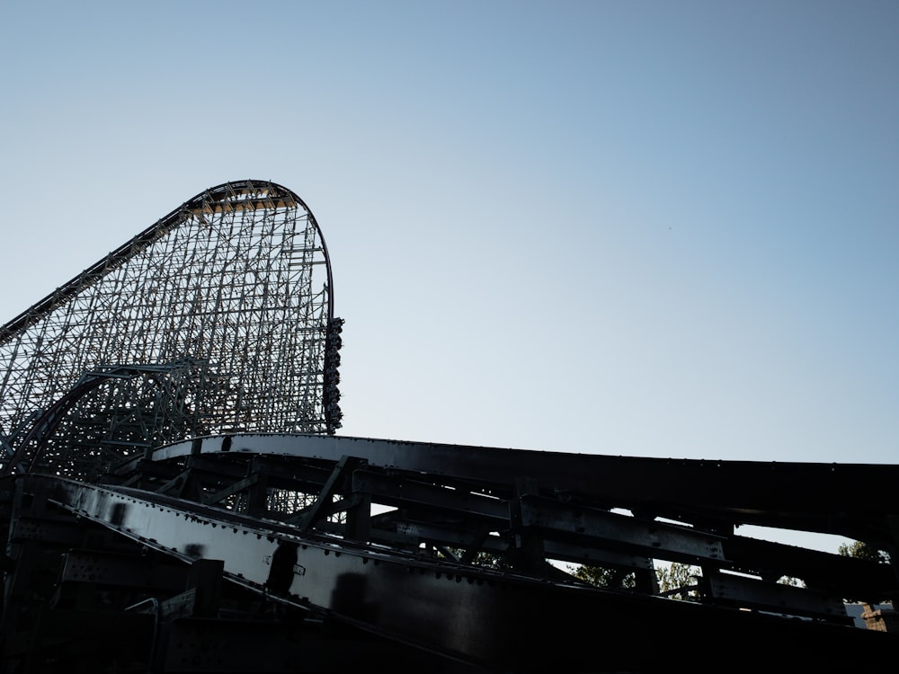 black roller coaster under blue sky during daytime
