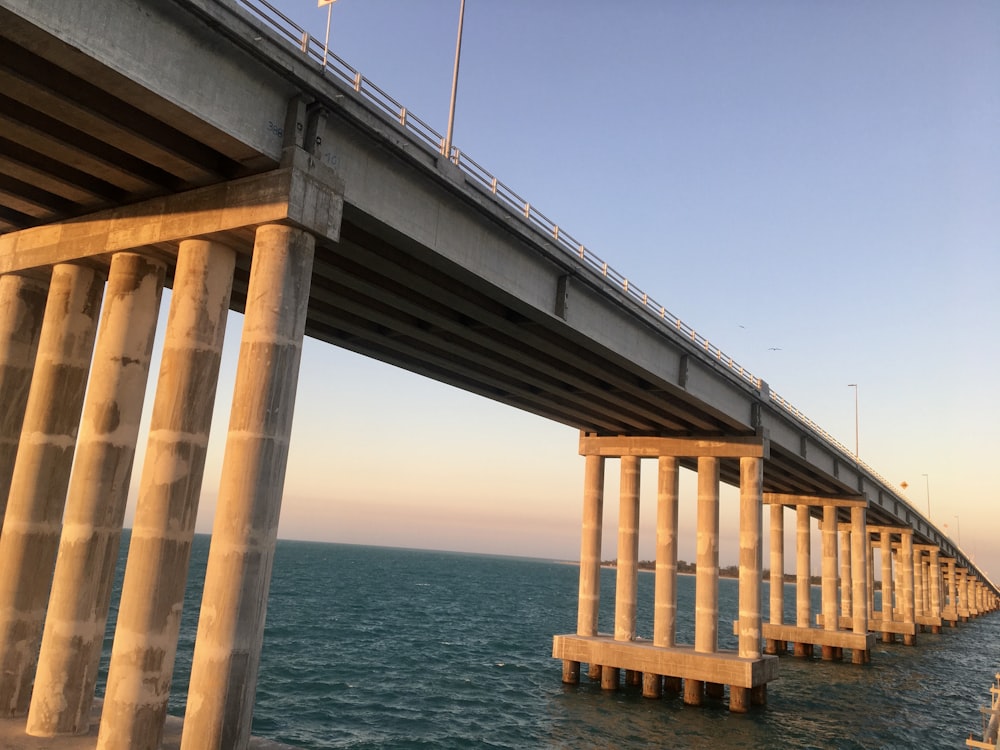 brown wooden bridge over blue sea during daytime