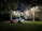 A cozy backyard setup with an inflatable screen and string lights.