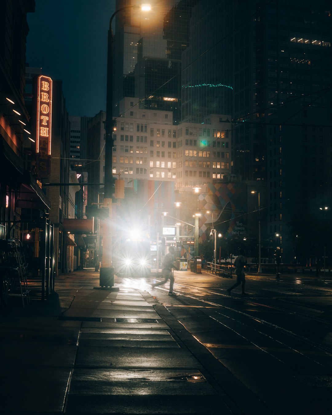 people walking on sidewalk during night time