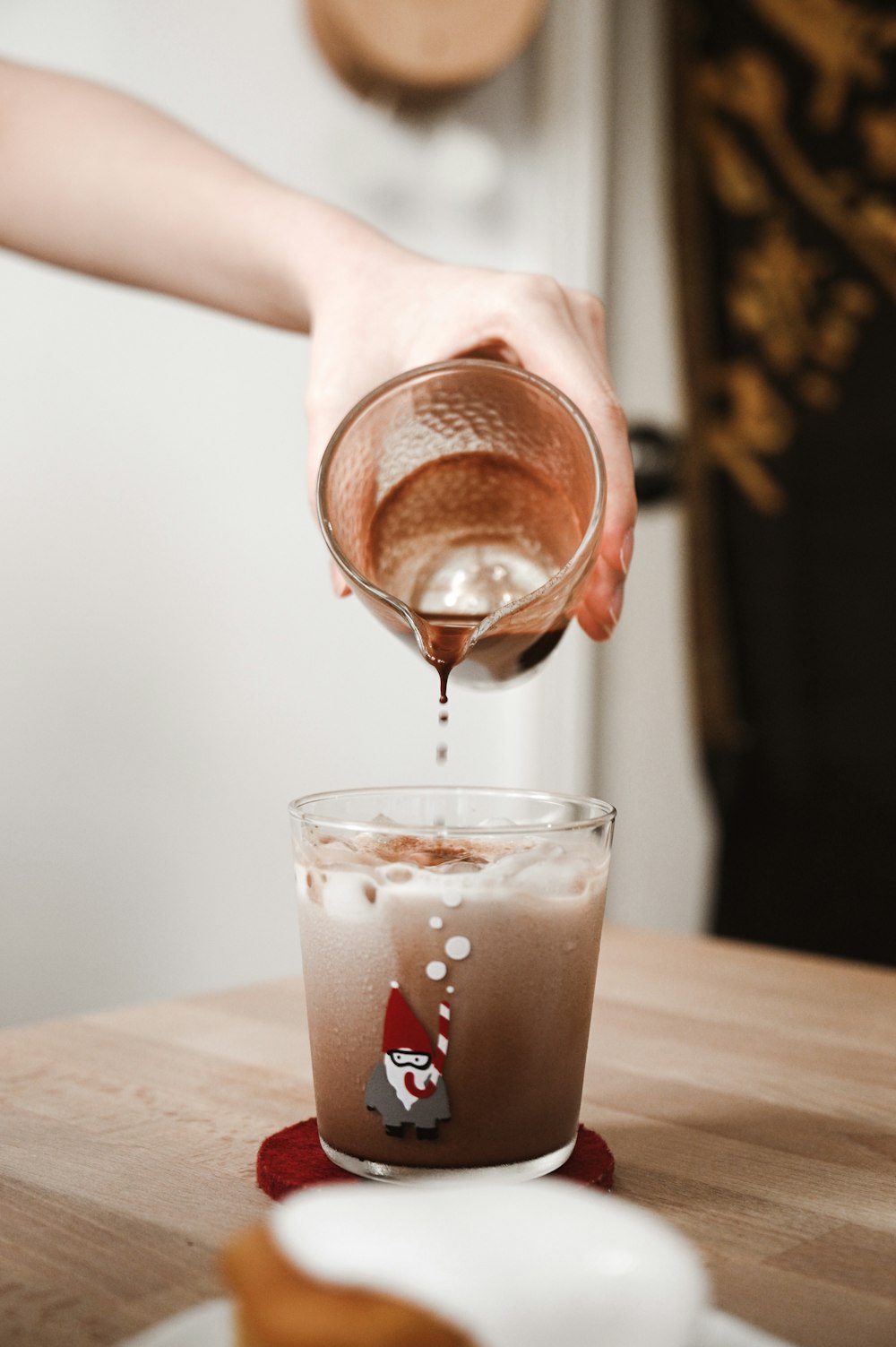 clear drinking glass with brown liquid