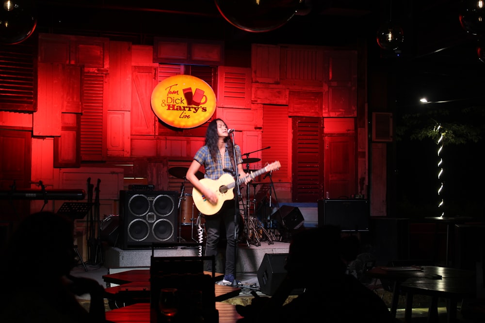 man playing guitar on stage